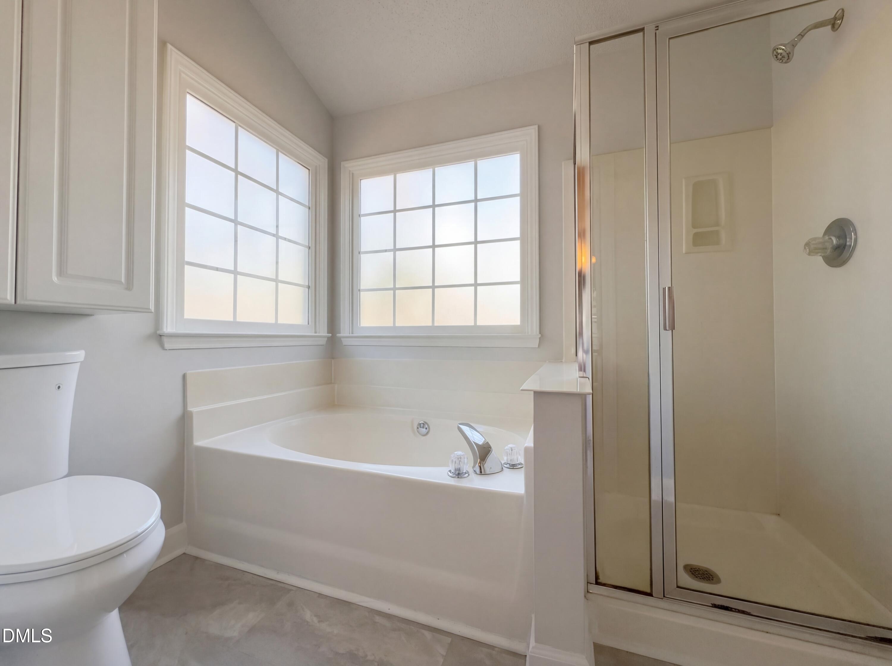 3117 Twatchman Drive Raleigh, NC 27616 - Photo 20 of 27 a bathroom with a bathtub and window
