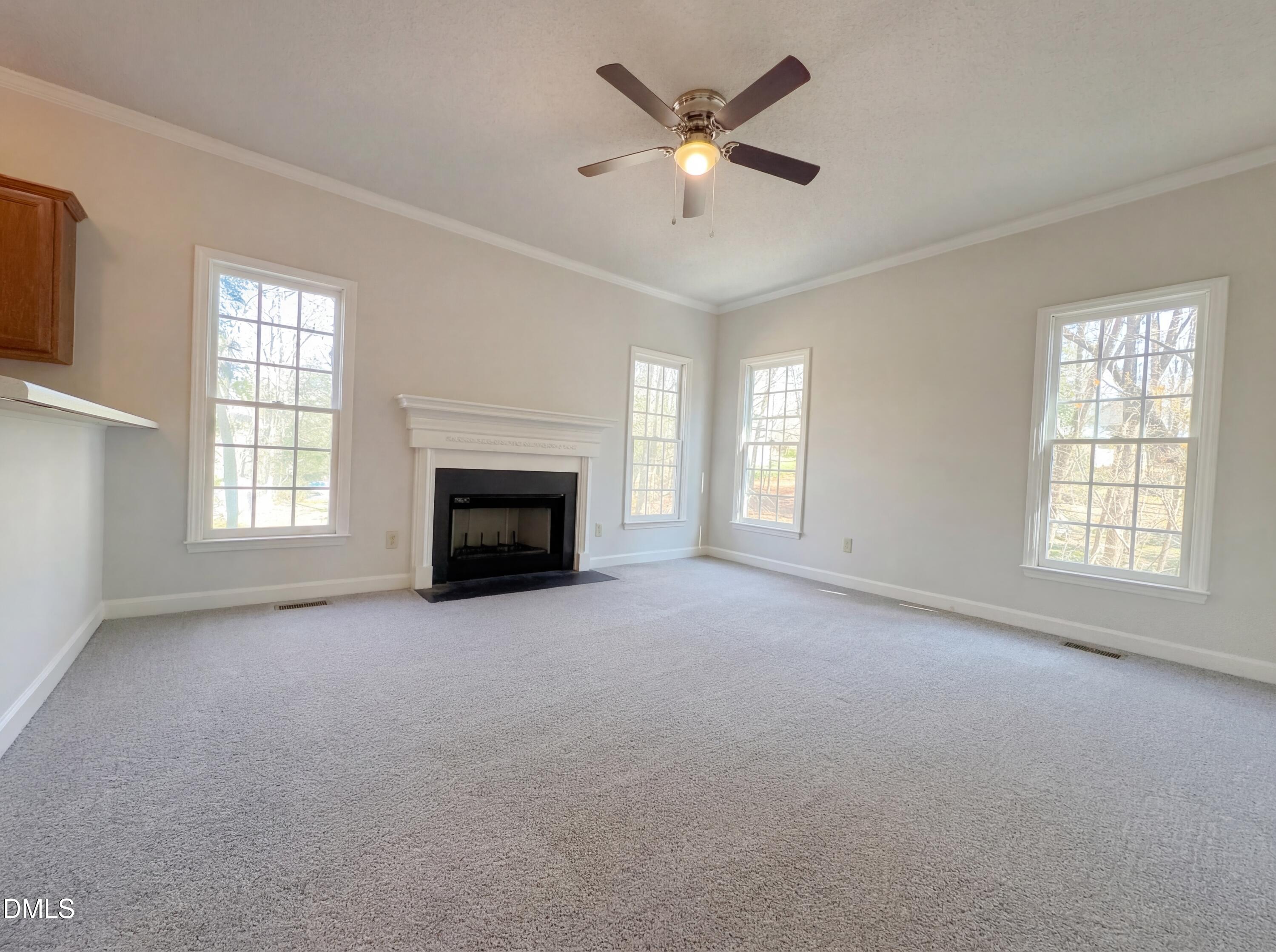 3117 Twatchman Drive Raleigh, NC 27616 - Photo 3 of 27 an empty room with windows and fireplace