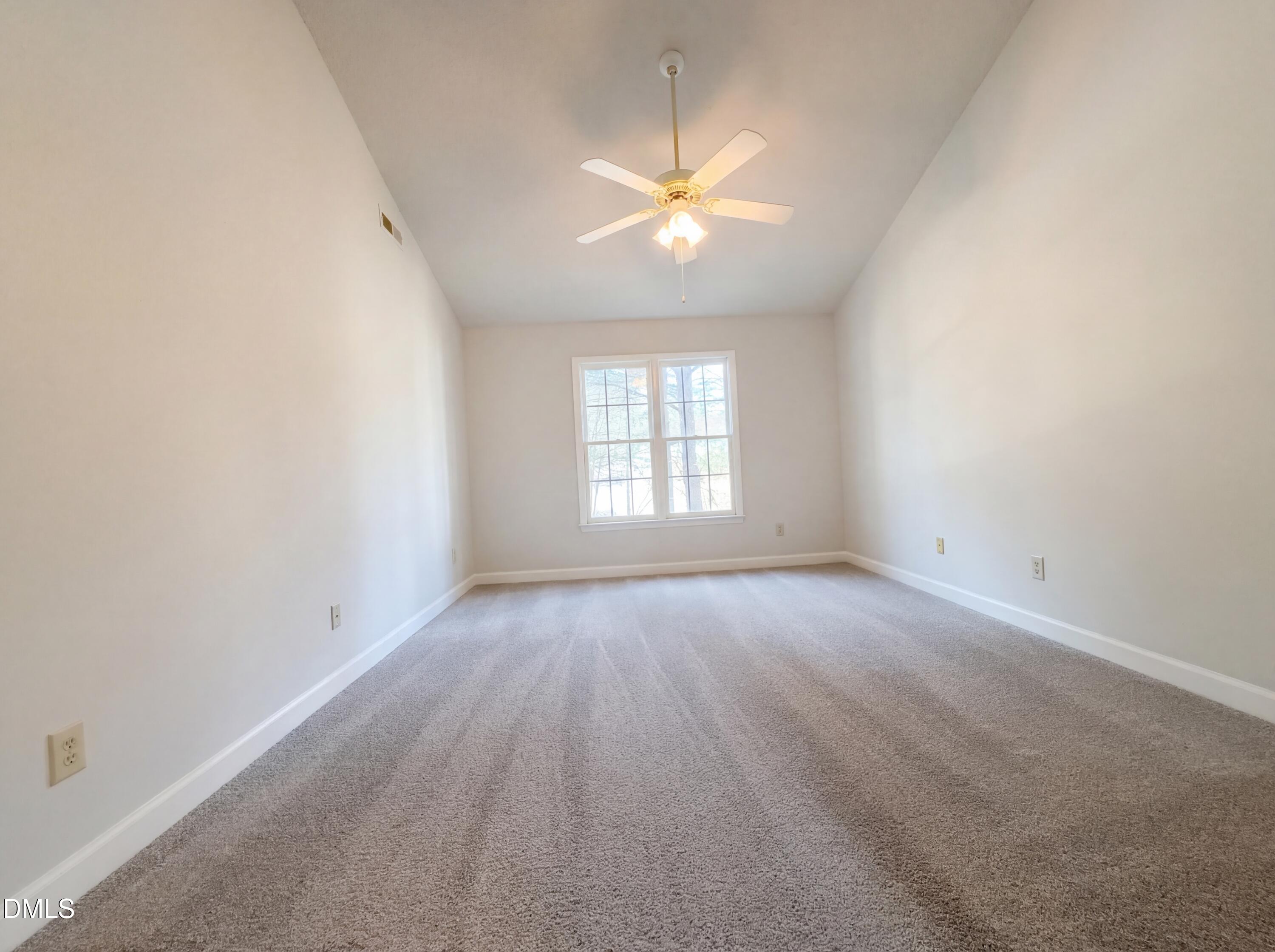 3117 Twatchman Drive Raleigh, NC 27616 - Photo 4 of 27 an empty room with a window and a ceiling fan