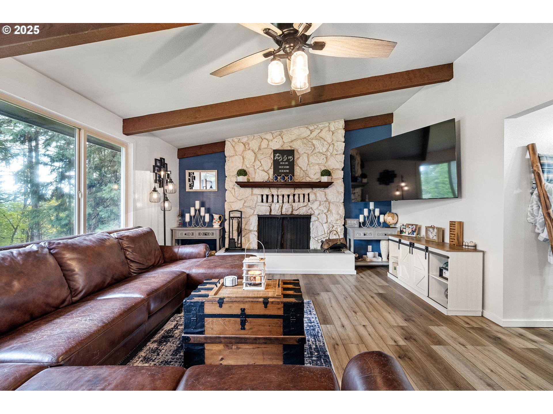 130 Tioga Court Cottage Grove, OR 97424 - Photo 18 of 44 a living room with furniture a flat screen tv and a fireplace