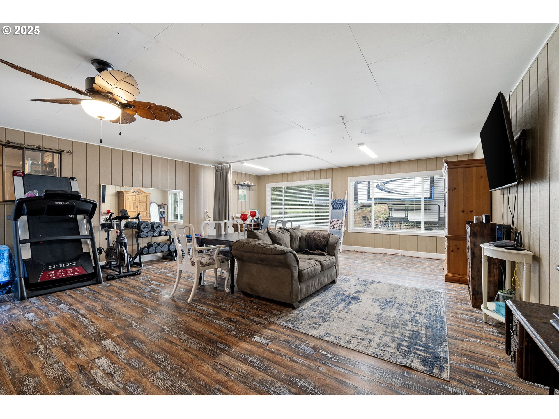 130 Tioga Court Cottage Grove, OR 97424 - Photo 42 of 44 a living room with furniture a flat screen tv and kitchen view