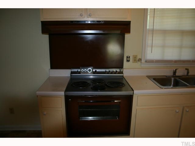 1507 Sedwick Road Durham, NC 27713 - Photo 3 of 12 a kitchen with a stove and a microwave