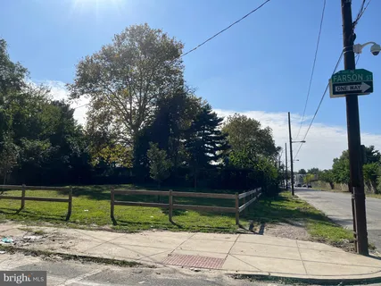 a view of backyard with wooden fence