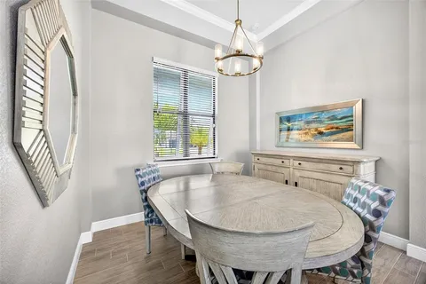 a dining room with furniture a chandelier and window