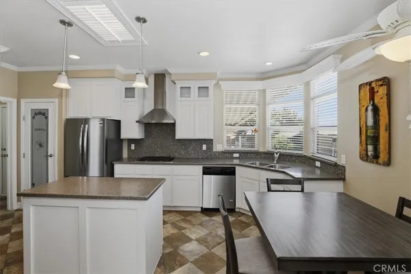 a kitchen with stainless steel appliances granite countertop a sink a stove top oven a counter space and cabinets