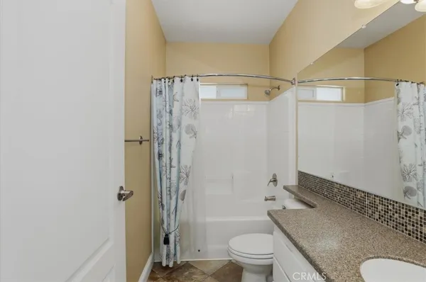a bathroom with a shower and a toilet
