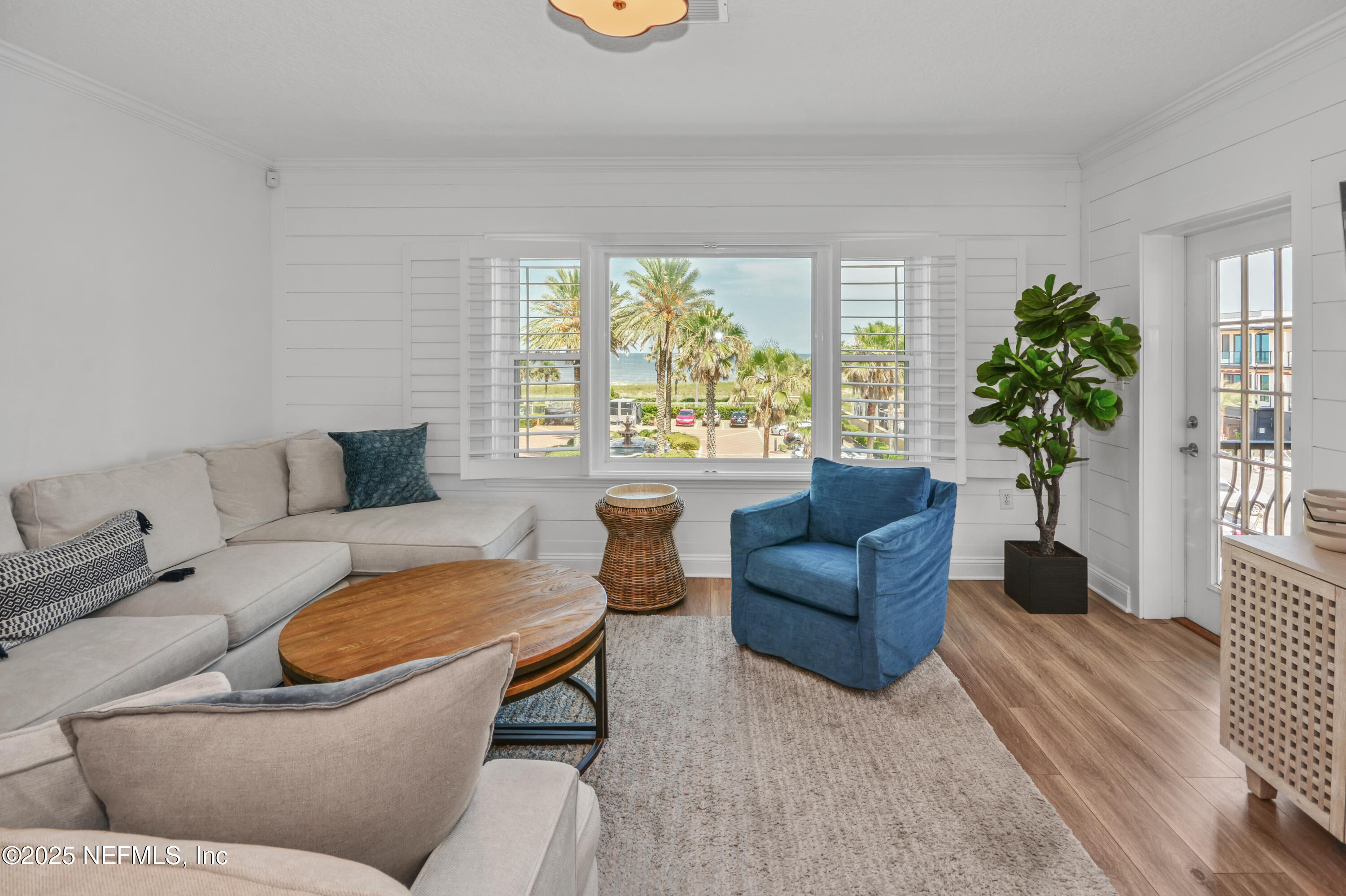 922 1st Street South, Unit 302 Jacksonville Beach, FL 32250 - Photo 11 of 28 a living room with furniture and a large window
