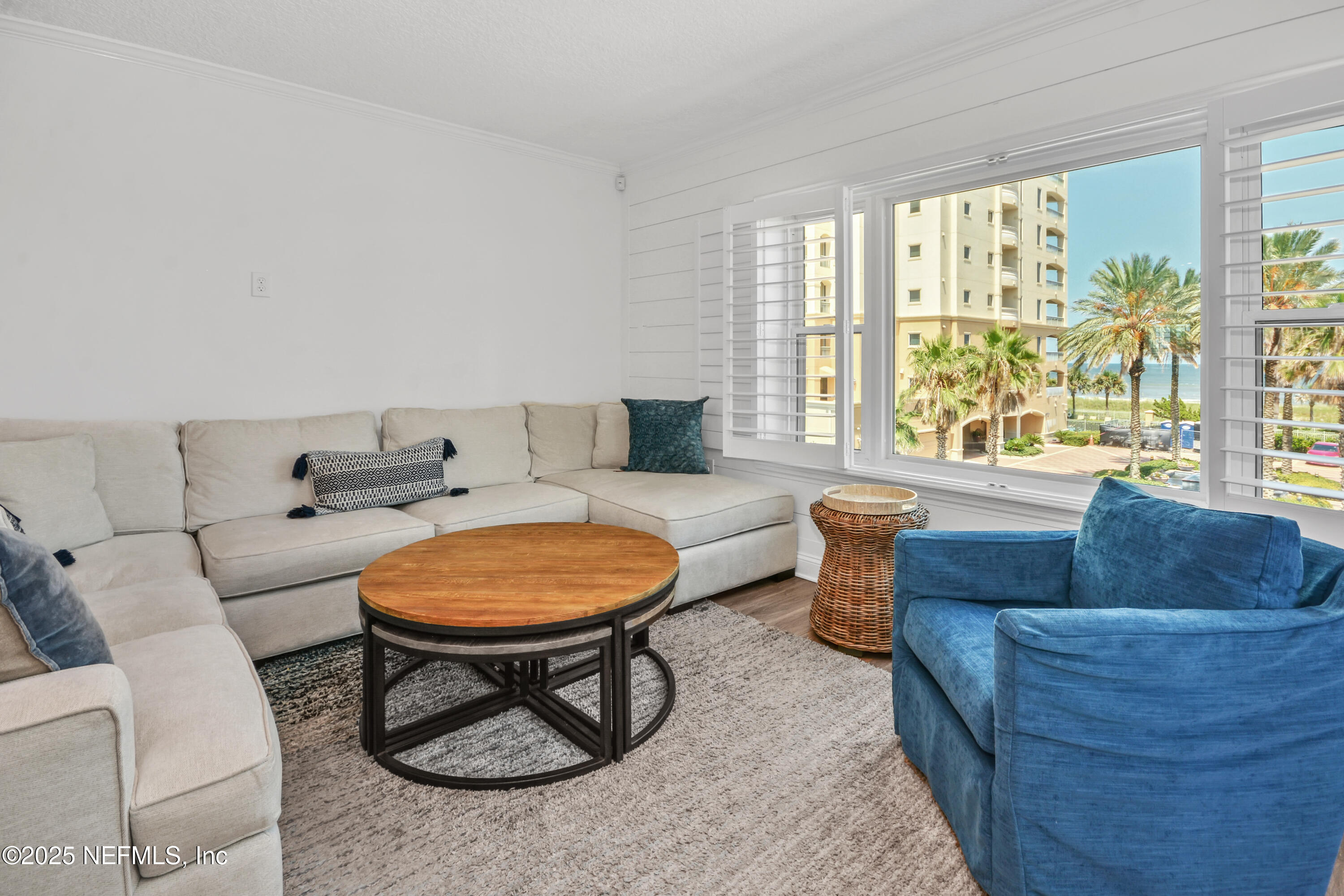 922 1st Street South, Unit 302 Jacksonville Beach, FL 32250 - Photo 12 of 28 a living room with furniture and a window