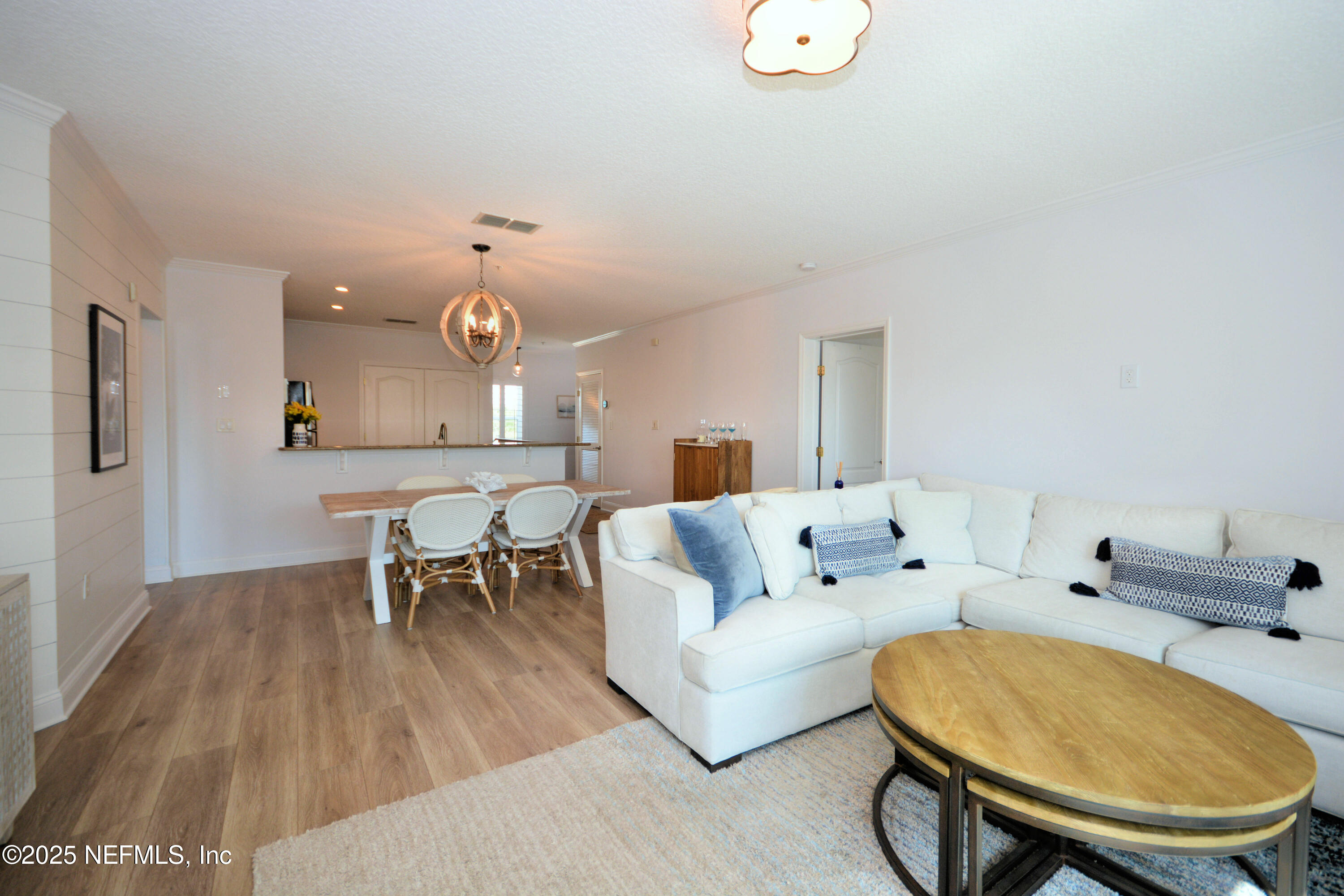 922 1st Street South, Unit 302 Jacksonville Beach, FL 32250 - Photo 13 of 28 a living room with furniture and a dining table