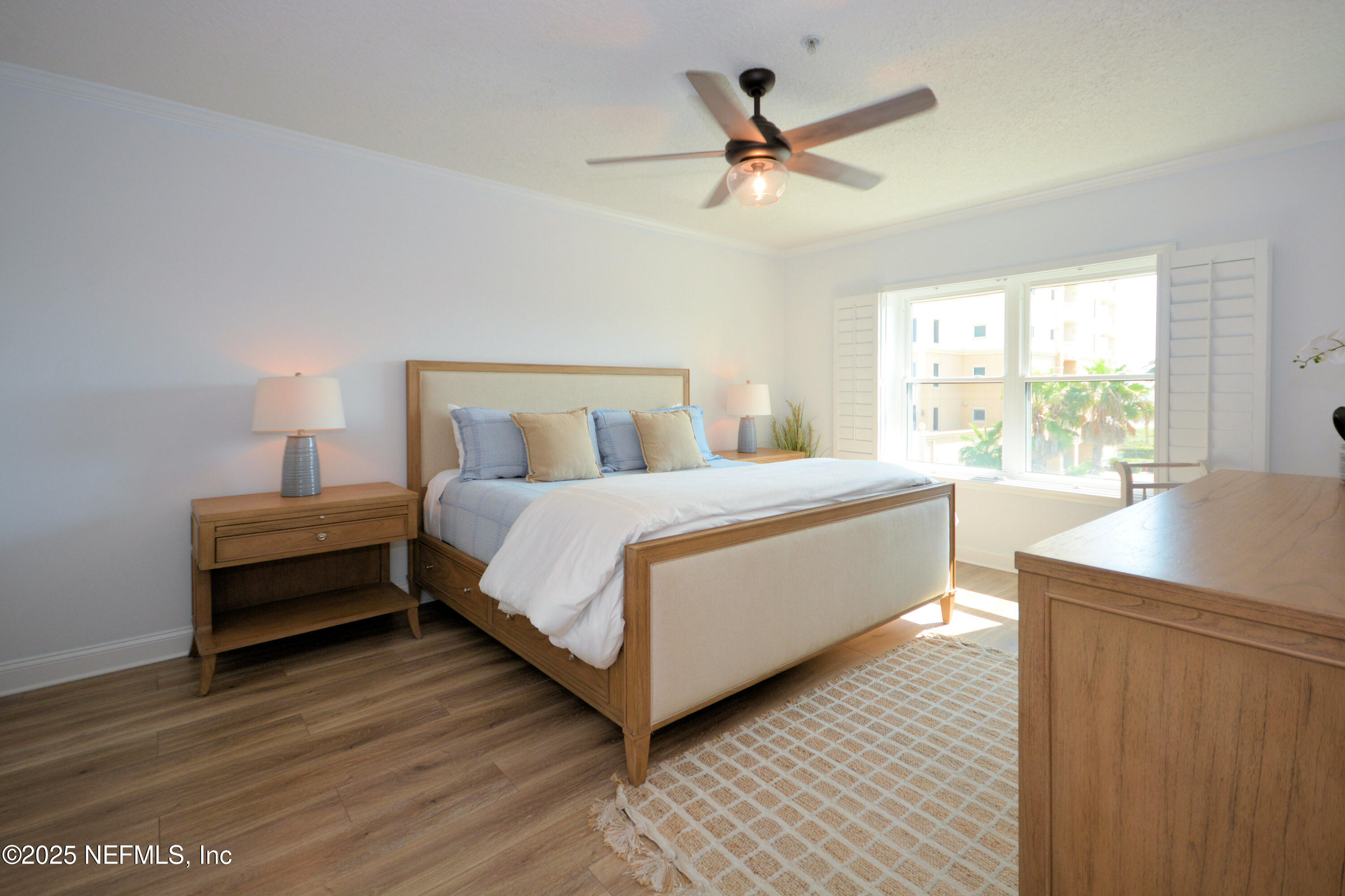 922 1st Street South, Unit 302 Jacksonville Beach, FL 32250 - Photo 15 of 28 a bedroom with a bed a window and a chandelier