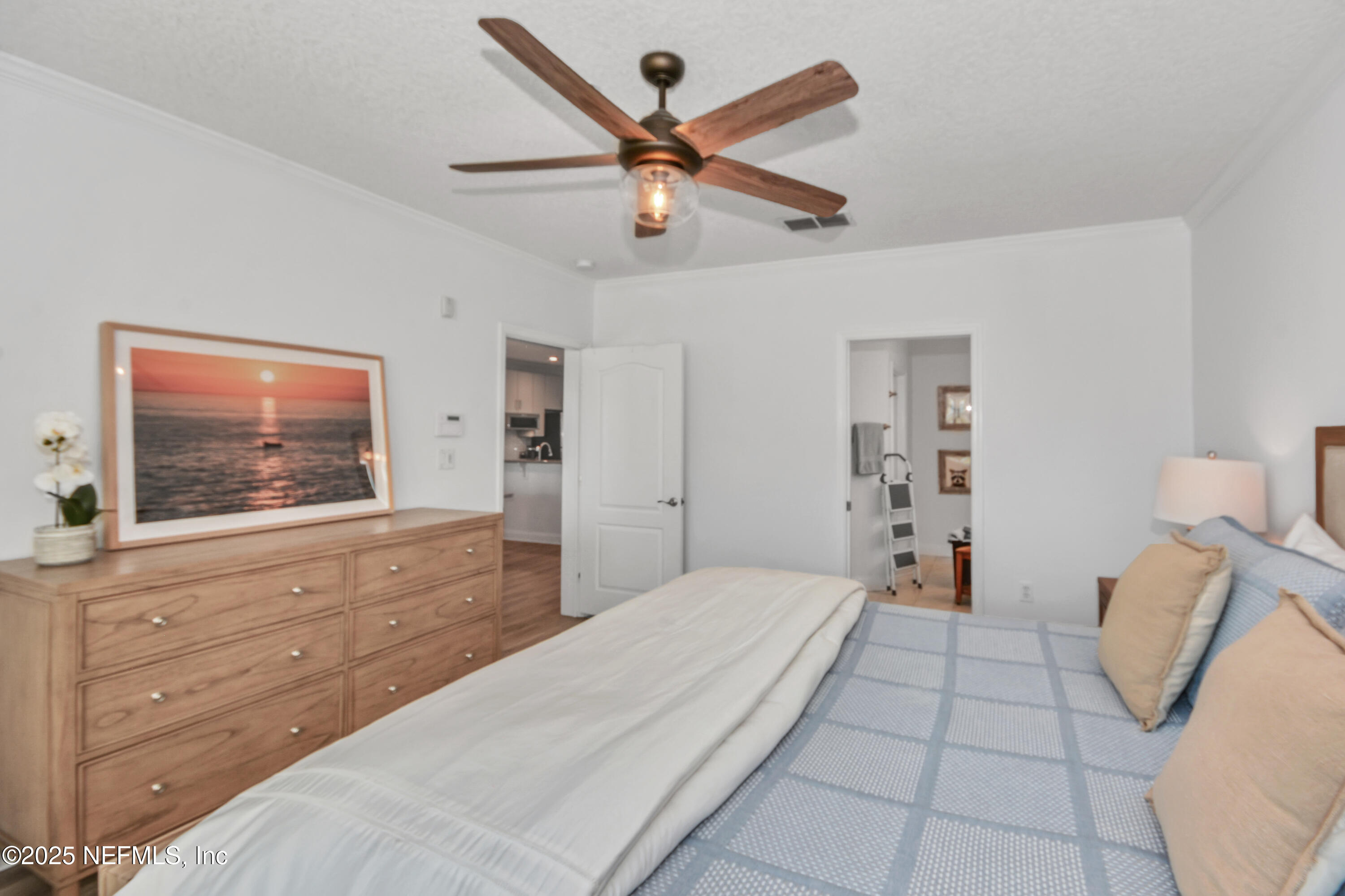 922 1st Street South, Unit 302 Jacksonville Beach, FL 32250 - Photo 17 of 28 a bedroom with a bed and a flat screen tv