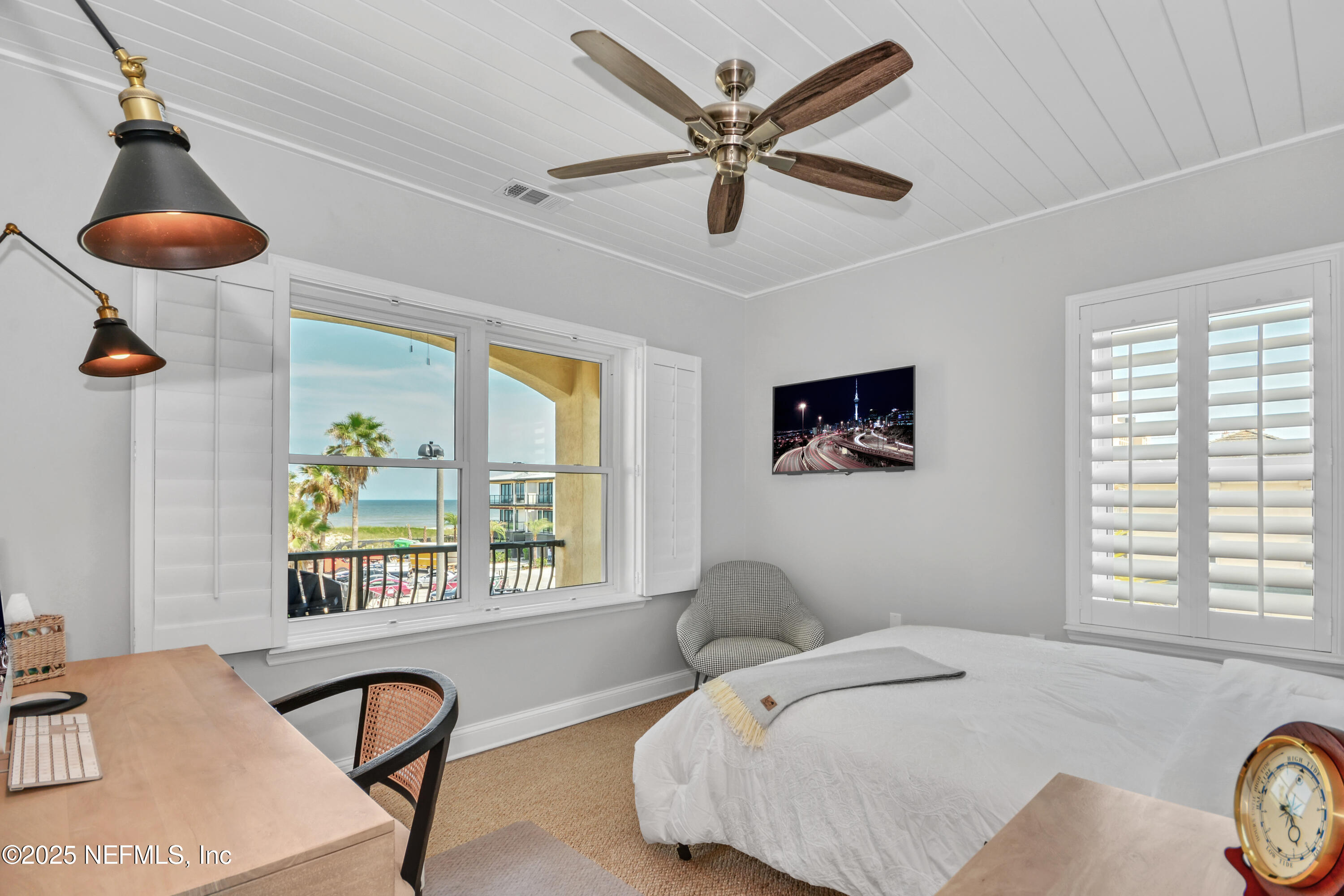 922 1st Street South, Unit 302 Jacksonville Beach, FL 32250 - Photo 21 of 28 a bedroom with furniture and a large window
