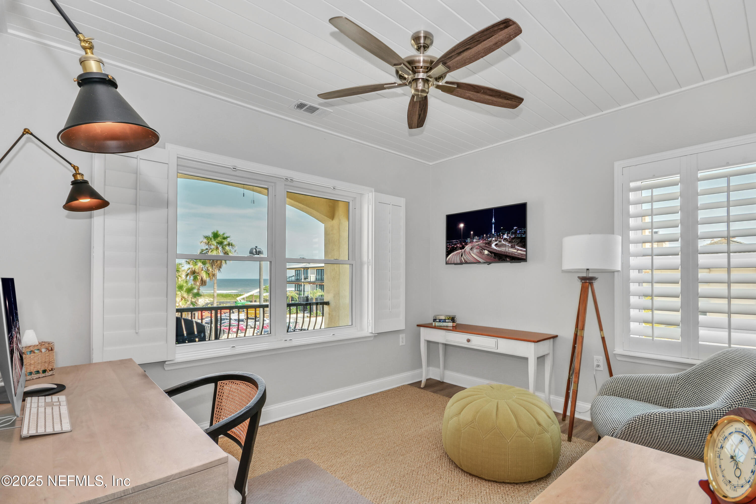 922 1st Street South, Unit 302 Jacksonville Beach, FL 32250 - Photo 22 of 28 a living room with furniture and a window