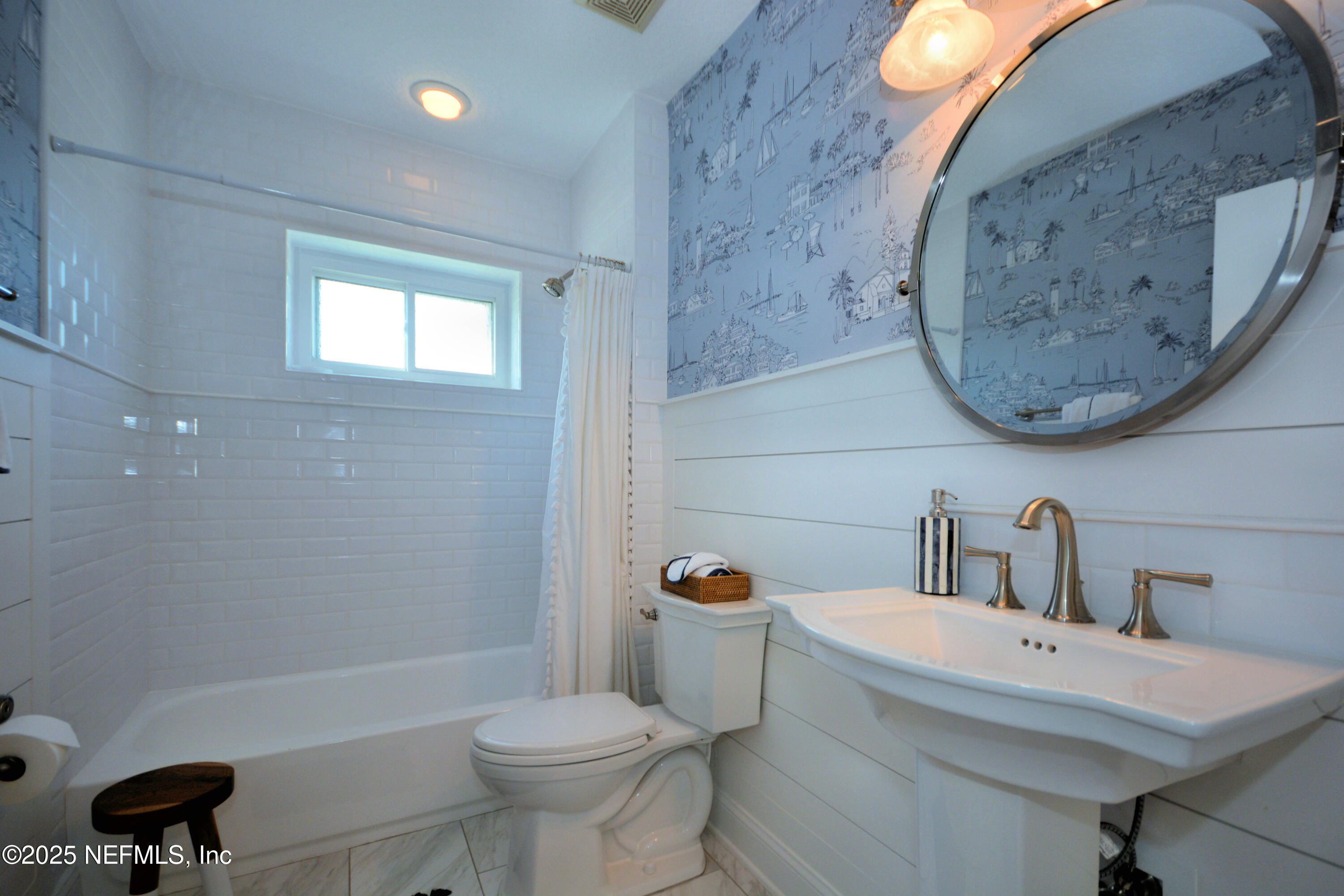 922 1st Street South, Unit 302 Jacksonville Beach, FL 32250 - Photo 23 of 28 a bathroom with a toilet sink and mirror