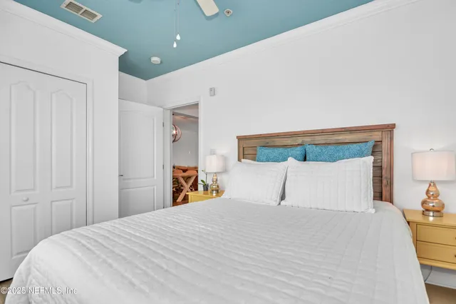 a bedroom with a bed and a mirror