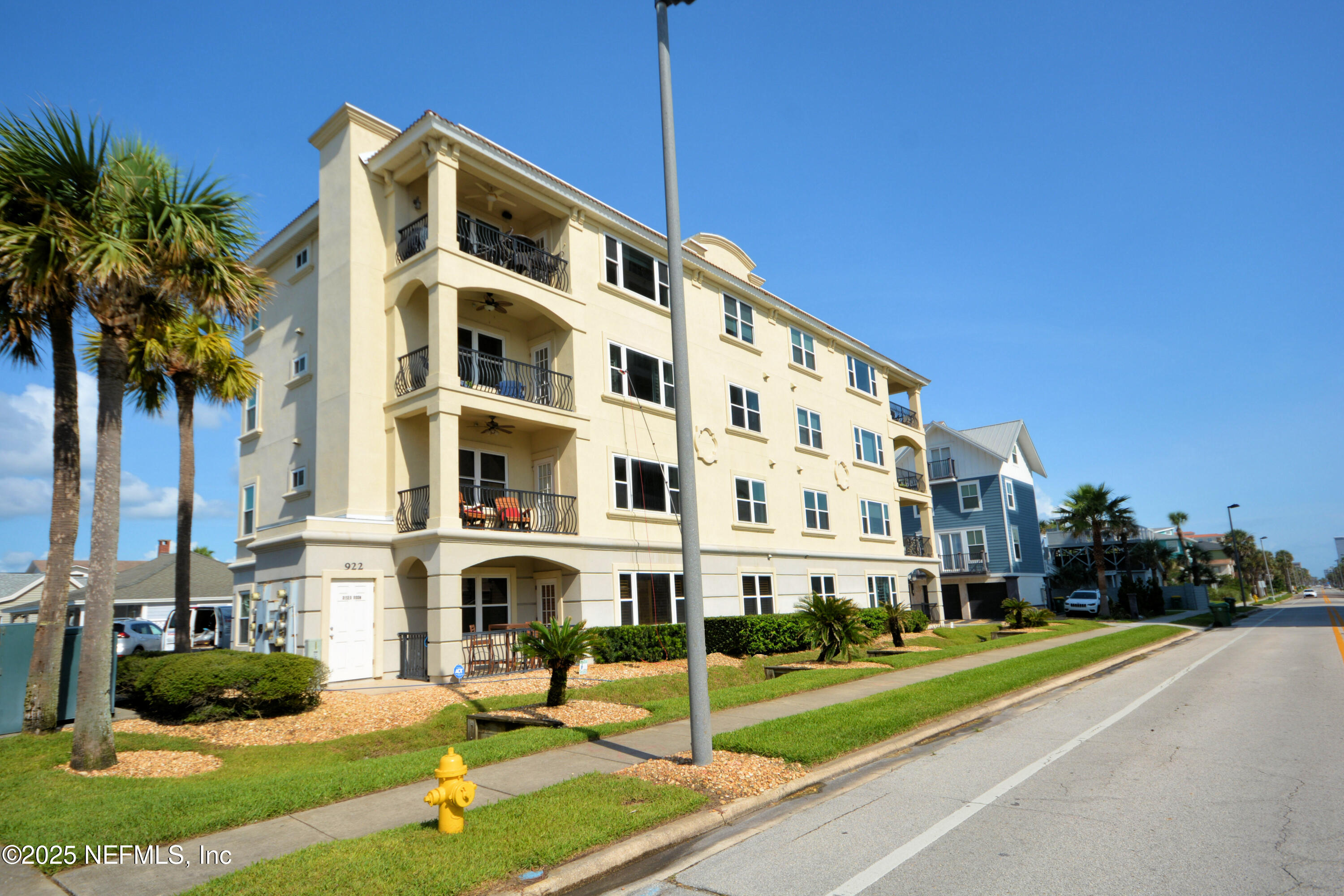 922 1st Street South, Unit 302 Jacksonville Beach, FL 32250 - Photo 26 of 28 a view of a brick building next to a yard