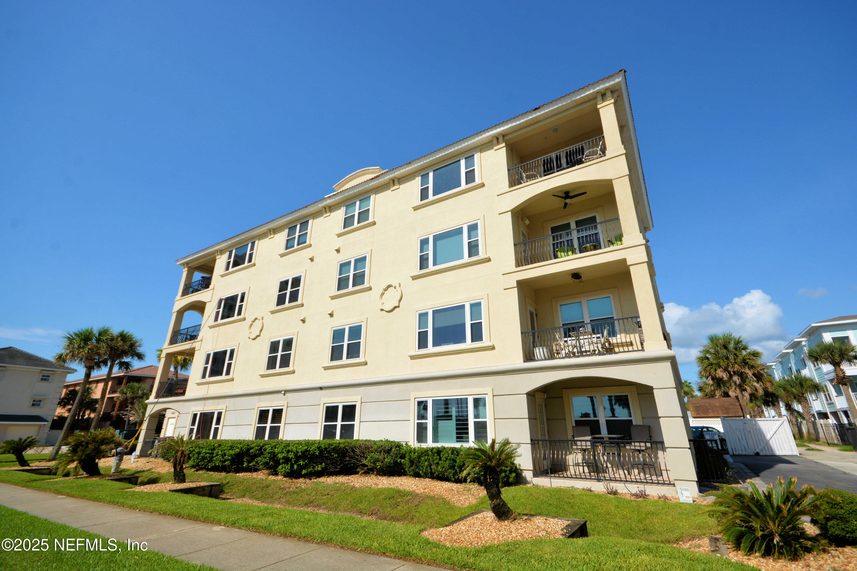922 1st Street South, Unit 302 Jacksonville Beach, FL 32250 - Photo 27 of 28 a view of a building with a yard