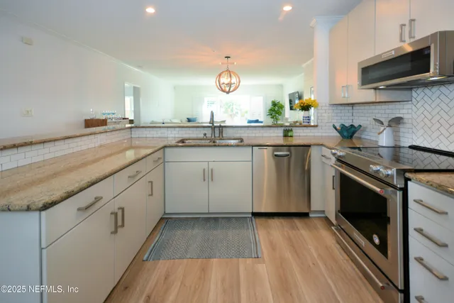 a kitchen with a sink stove and microwave