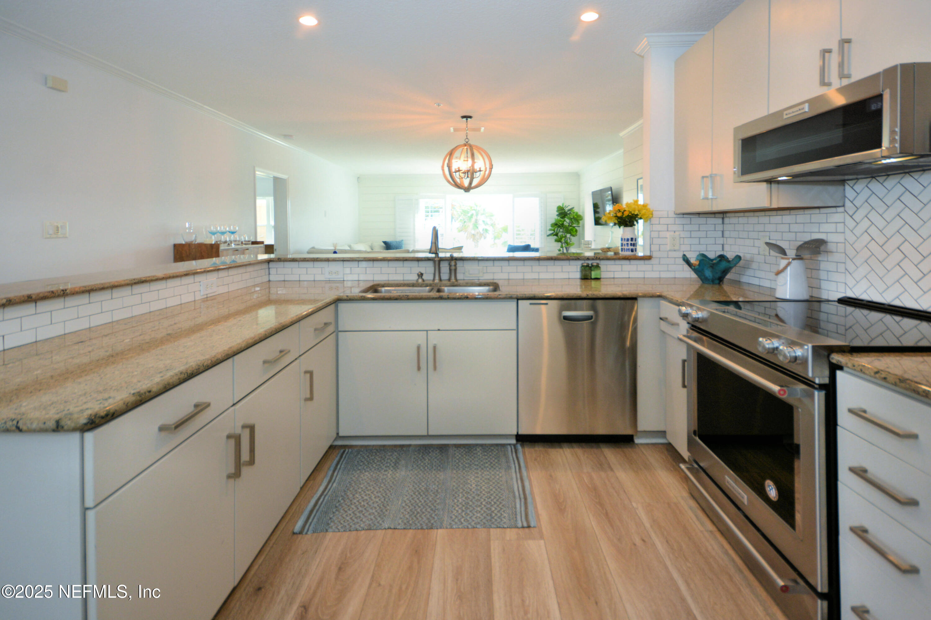 922 1st Street South, Unit 302 Jacksonville Beach, FL 32250 - Photo 4 of 28 a kitchen with a sink stove and microwave