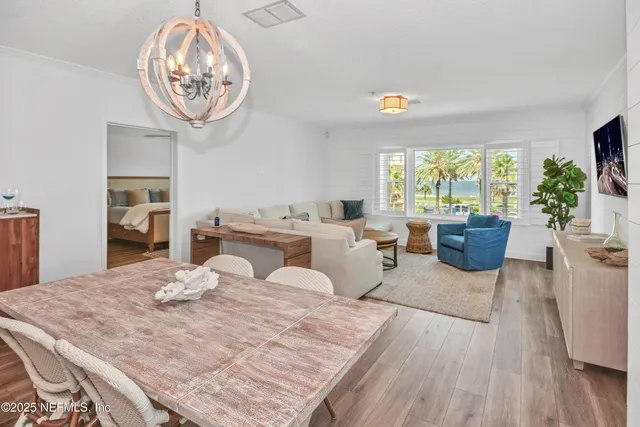 a living room with furniture a window and a dining table