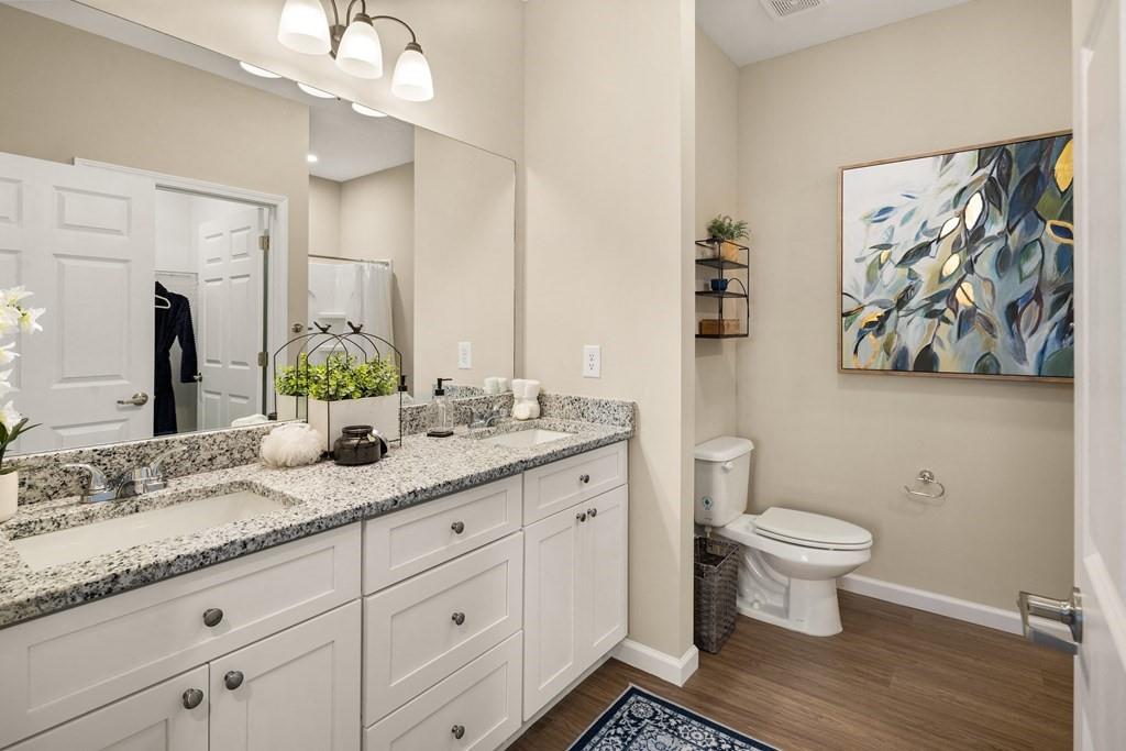 100 Harvest Grove Lane, Unit HAYES Calhoun, GA 30701 - Photo 12 of 16 a bathroom with a granite countertop toilet sink and mirror