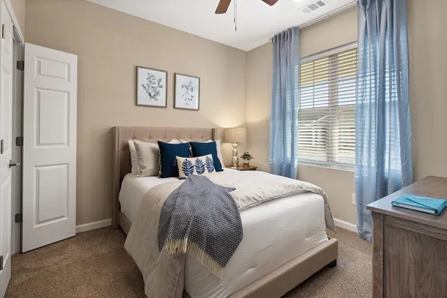 a bedroom with a bed and a window