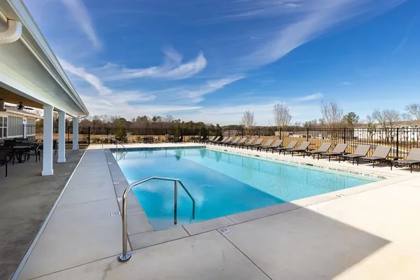 a view of a swimming pool with outdoor seating
