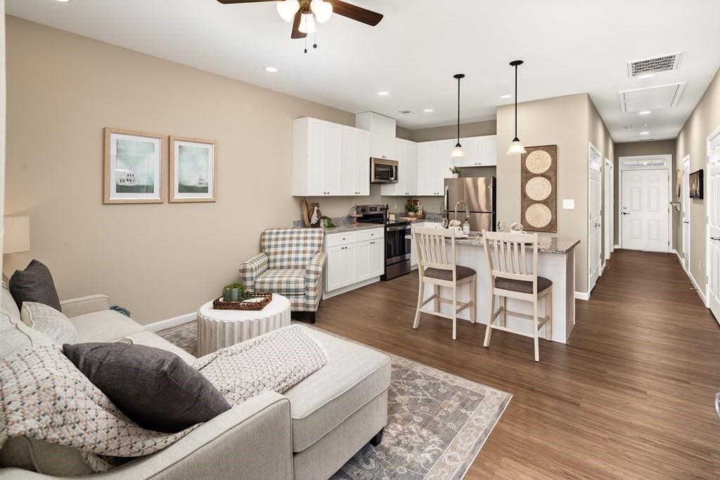 100 Harvest Grove Lane, Unit HAYES Calhoun, GA 30701 - Photo 10 of 16 a living room with furniture kitchen view and a wooden floor