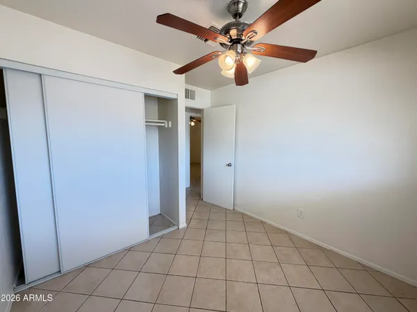 a view of an empty room with a fan