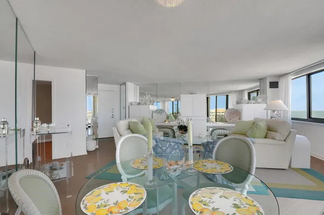 a living room with furniture a table and chairs