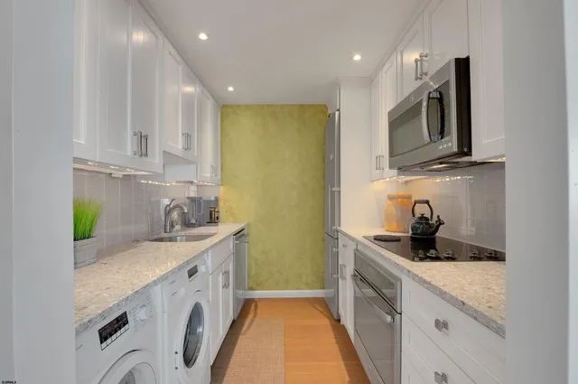 a kitchen with a sink and a stove top oven