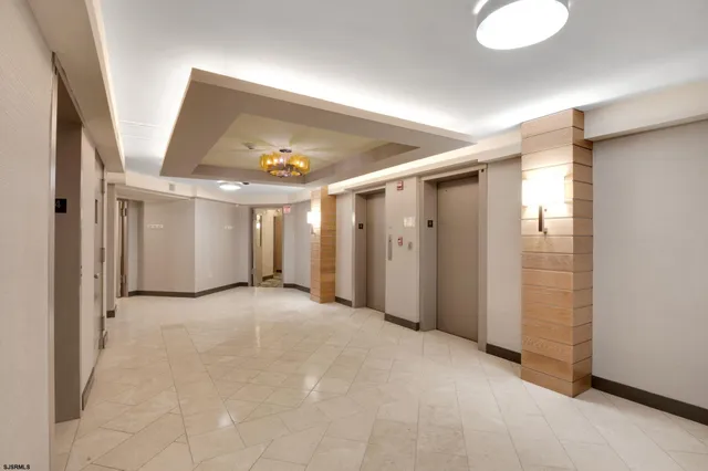 a view of a hallway with closet and bathroom