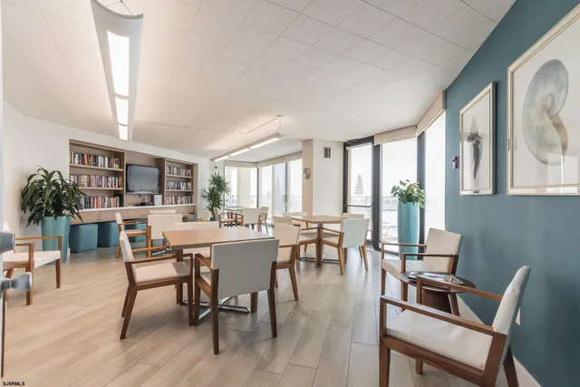 a dining room with furniture window and wooden floor