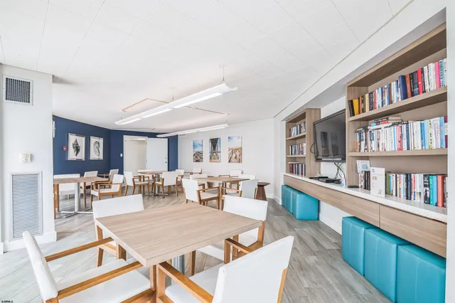 a living room with lots of furniture and a book shelf