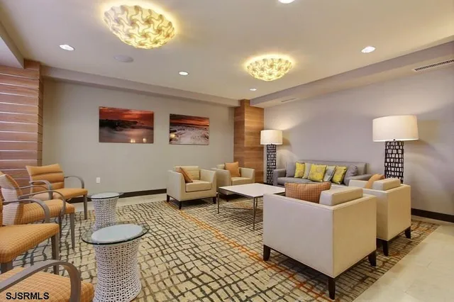 a living room with furniture and a lamp