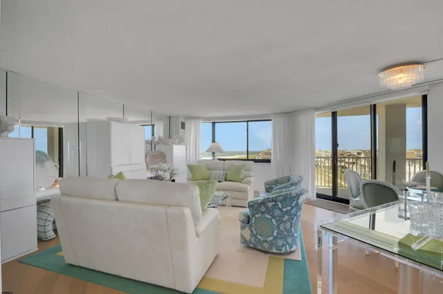 a living room with furniture and large windows