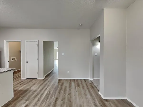 a view of an empty room and wooden floor