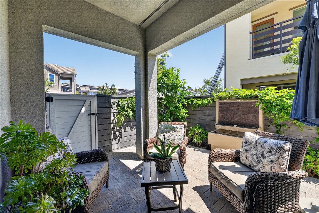752 Sunrise Road Rancho Mission Viejo, CA 92694 - Photo 15 of 73 a view of a patio with couches chairs potted plants and wooden floor