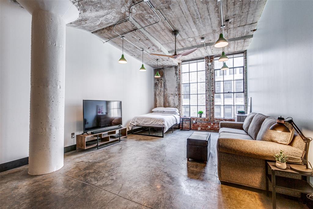 1122 Jackson Street, Unit 917 Dallas, TX 75202 - Photo 3 of 21 a living room with furniture a flat screen tv and a window