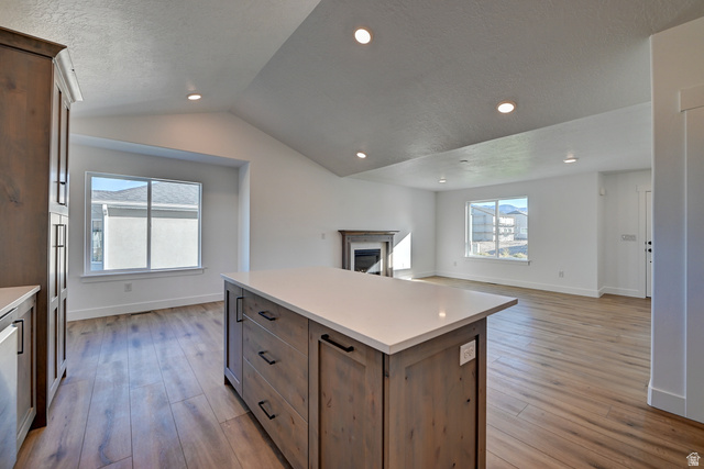 1848 Mantle Way, Unit 417 Tooele, UT 84074 - Photo 4 of 6 Kitchen island with a light-toned countertop and wood-finish cabinetry
