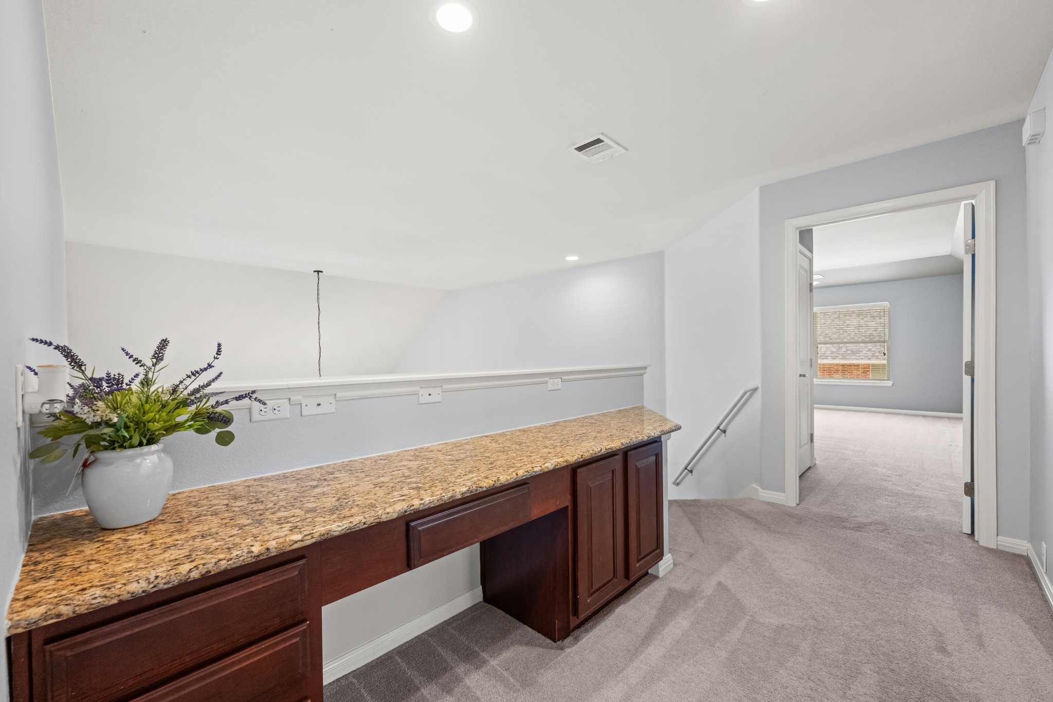 1023 Grassy Field Road Austin, TX 78737 - Photo 23 of 40 Integrated built-in desk with a granite-style countertop and dark wood-finish cabinetry