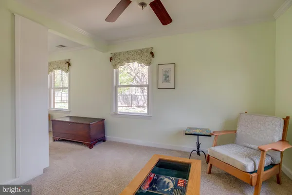 a view of a white house next to a road with a house