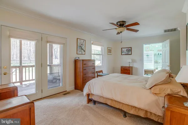 a view of three house with yard and trees in the background