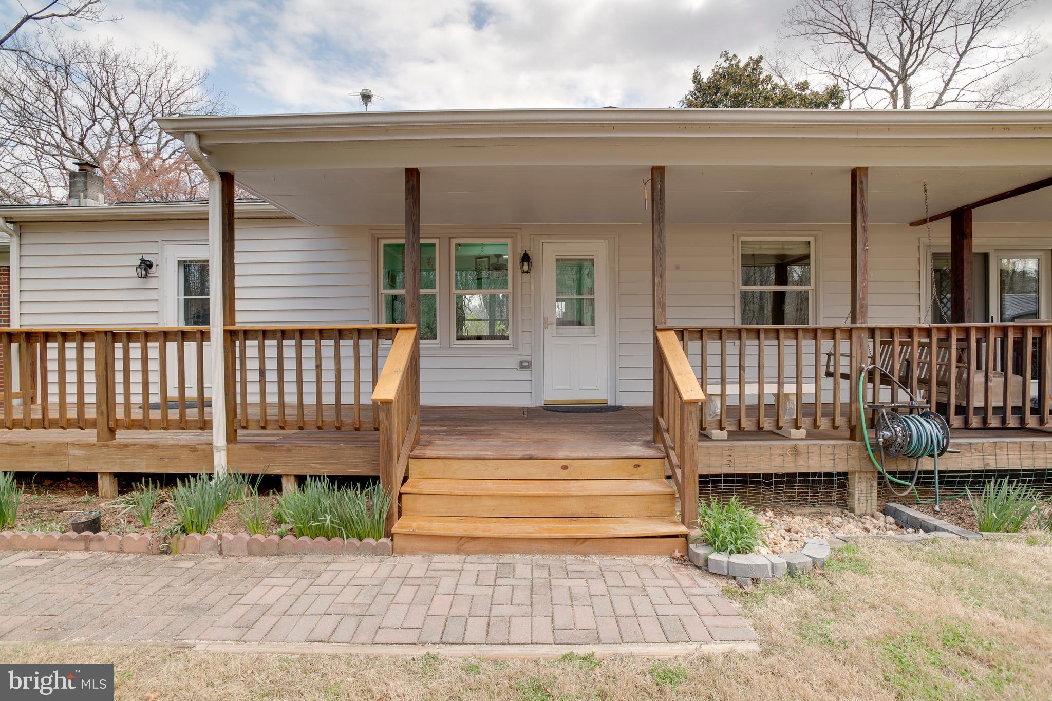 20174 Edwards Shop Road Elkwood, VA 22718 - Photo 5 of 54 a view of a house with wooden deck and furniture