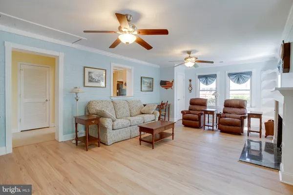 a view of a house with wooden deck and furniture
