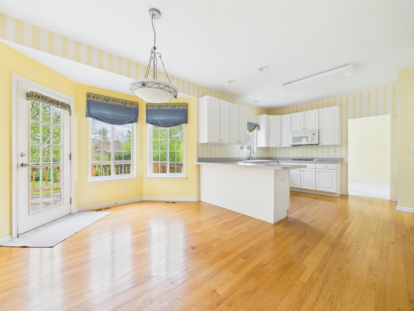 7486 Abbey Road Gurnee, IL 60031 - Photo 12 of 35 a view of a kitchen with granite countertop cabinets and a wooden floor