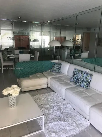 a living room with furniture fireplace and chandelier