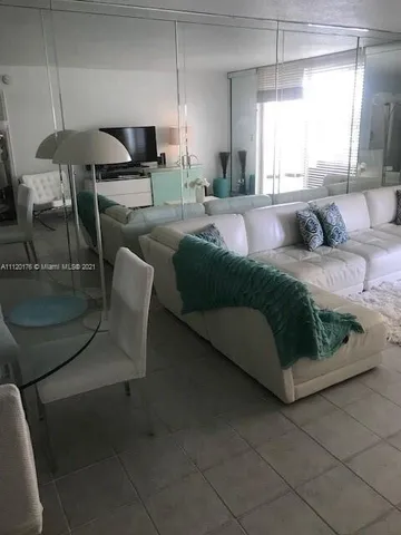 a living room with a couch and a potted plant