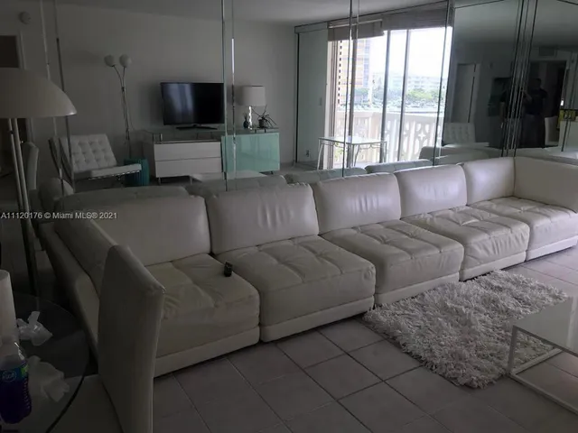 a living room with couches and a flat screen tv