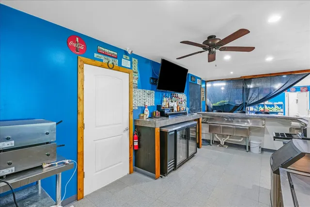 a kitchen with kitchen island a stove and a microwave